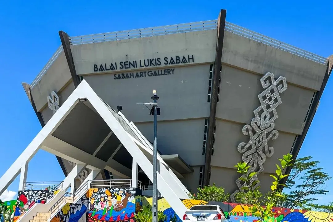 The Sabah Art Gallery, signed Balai Seni Lukis Sabah, an inverted-cone concrete building with a woven tribal motif down its facade.