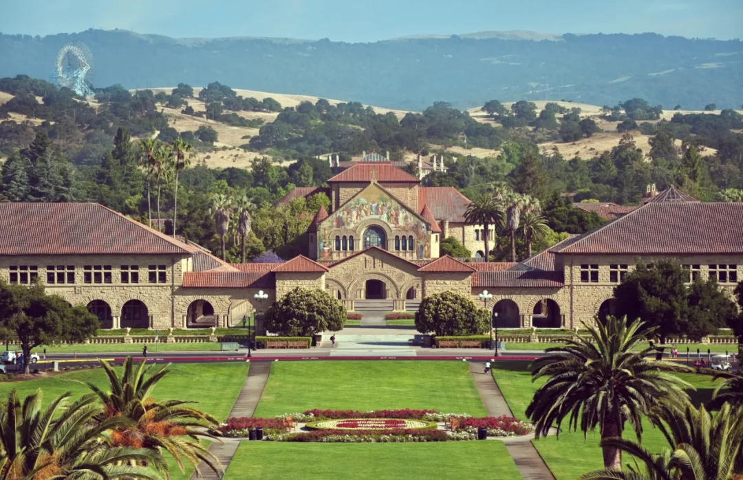 Stanford's Main Quad, the mosaic facade of Memorial Church framed by palms and lawns.
