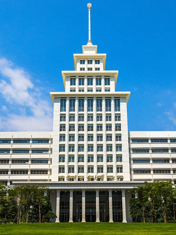 The white stepped main building of Harbin Institute of Technology, Shenzhen, under a clear blue sky.