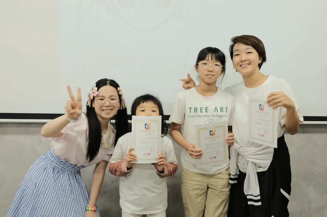 An instructor and three students in TREE ART shirts holding up their certificates