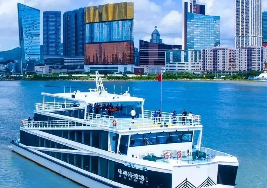 The Zhuhai-Macau sightseeing catamaran passing Macau's waterfront hotel towers.